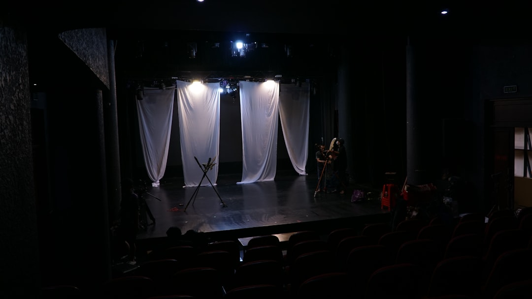 services-02 stage-with-white-curtains-and-dim-lights-3xkycsmi9n8