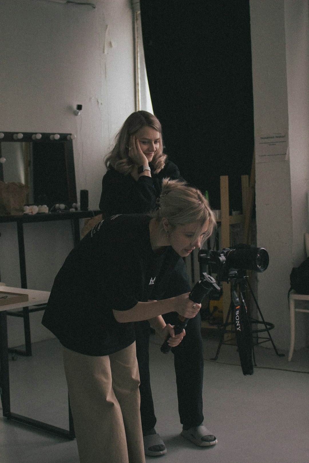 about-us-01 two-women-are-filming-with-a-camera-on-a-tripod-3xdfzdxun4o